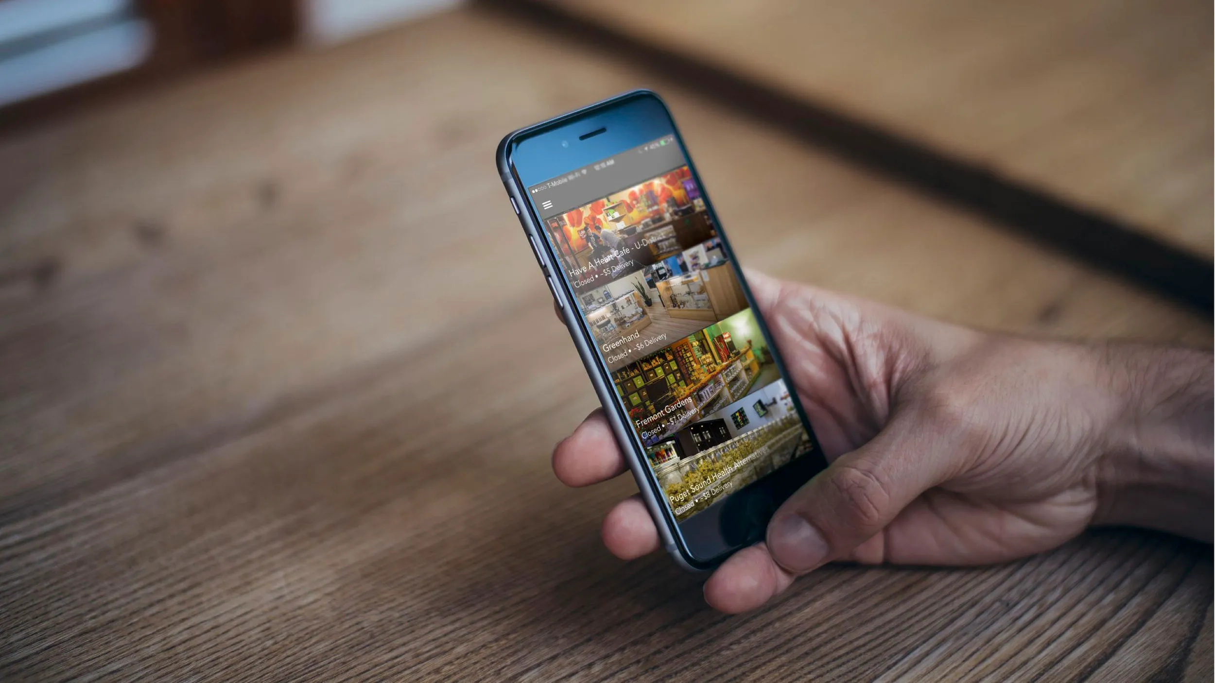 Hand holding a phone showing a travel app